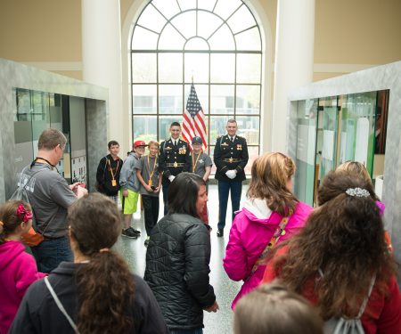Members of The Old Guard pose for photographs in the Welcome Center of Arlington National Cemetery