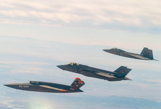 A U.S. Air Force F-22 Raptor and F-35A Lightning II fly in formation with the XQ-58A Valkyrie low-cost unmanned aerial vehicle over the U.S. Army Yuma Proving Ground testing range, Ariz., during a series of tests Dec. 9, 2020. This integrated test follows a series of gatewayONE ground tests that began during the inaugural Department of the Air Force on-ramp last year in December. Courtesy photo.