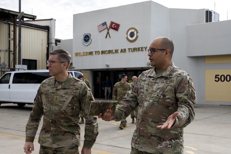 Maj. Gen. John Klein, U.S. Air Force Expeditionary Center commander, left, speaks with Senior Master Sgt. Adrian E. Holguin, 728th Air Mobility Squadron aerial port superintendent, at Incirlik Air Base, Turkey, Feb. 25, 2023.