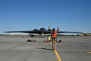 A crew chief assigned to the 393rd Expeditionary Bomb Squadron, ushers a B-2 Spirit in Keflavik, Iceland to participate in a Bomber Task Force Europe operation with NATO allies, Aug. 13, 2023.