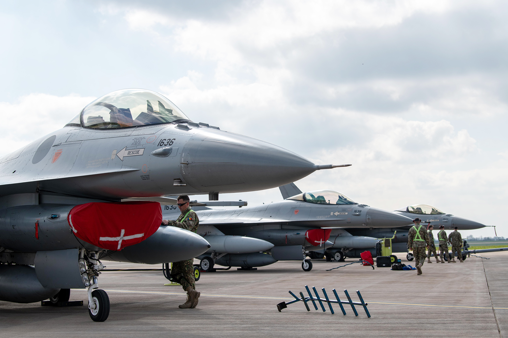 A Turkish Air Force A400M Atlas taxis past three Romanian Air Force F-16s at RAF Fairford, U.K.